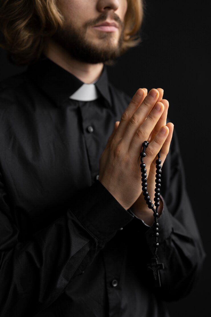 close-up-pastor-praying-with-rosary_23-2149300834.jpg